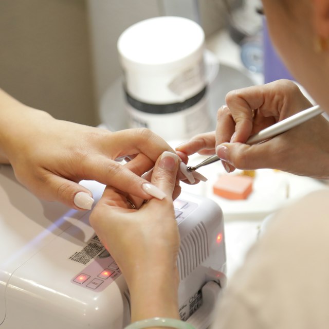 Polished manicure with healthy cuticle care at salon station